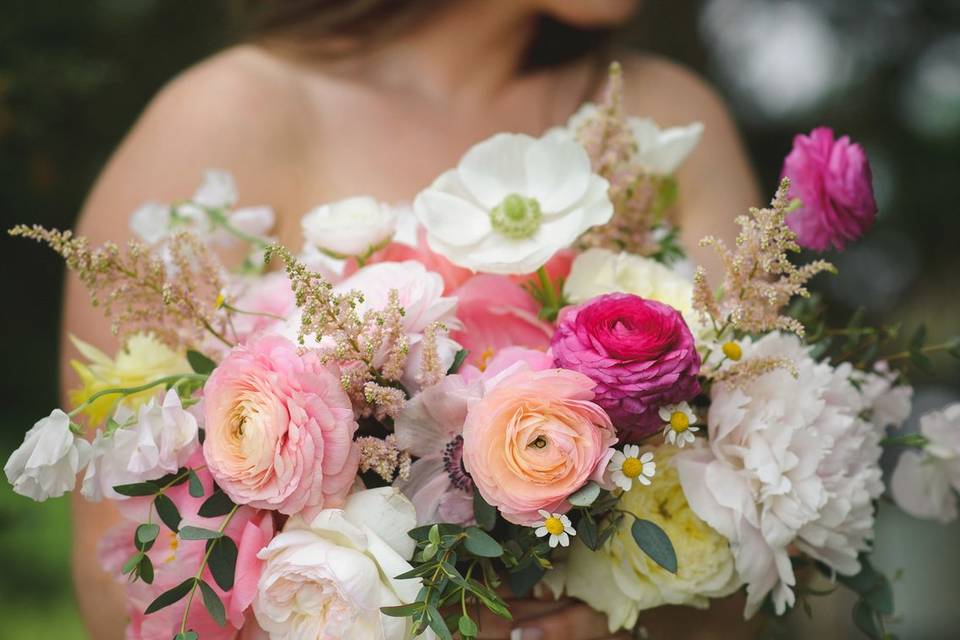 Colorful bride's bouquet with Anemones, Ranunculus, Garden roses, Coral Peonies, Astilbes.