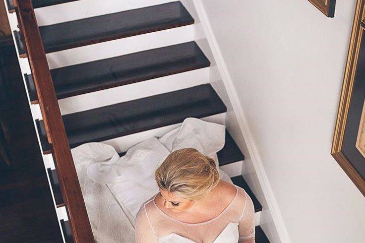 Bride sitting by the stairs