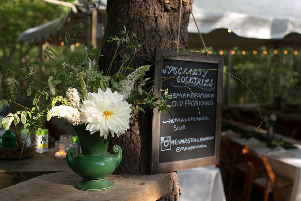 Moss and electric candles on tree stumps create a 