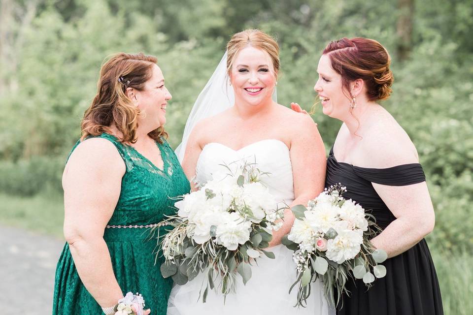 The bride with friends holding bouquets