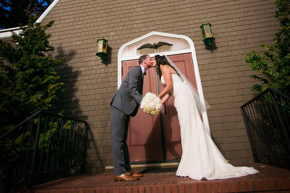 Couple in kiss in front of church - Donna Beck Photography