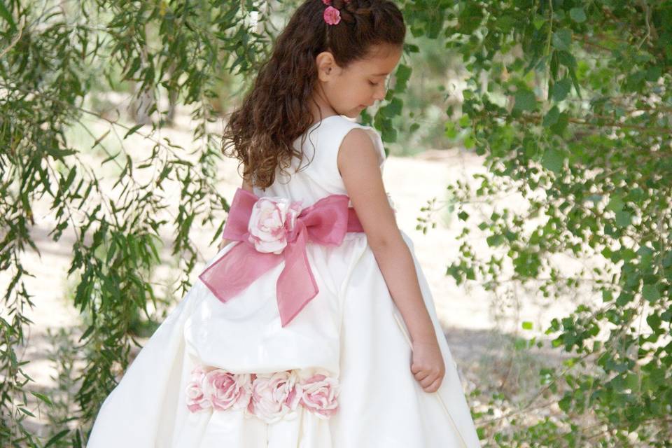 This flower girl dress is one of my original designs Made of Duchess satin, fully lined, and has a built-in petticoat. Just add one adorable flower girl!
The back has a beautiful bustle and a slight lace train. I went with Ivory and Pink on this dress but could easily be made with another color scheme of your choosing.
It comes with:
~ a sash in the color of your choosing(Ribbon, Satin, Organza, or Dupioni)
~ handmade flowers, plus one mounted on a hair clip.