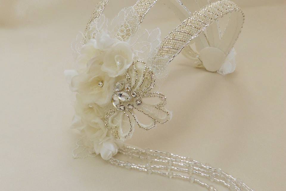 This Vintage Style Juliet Cap Headpiece has handmade cherry blossoms, Chantilly and Venice lace, and plenty of gorgeous beading. A veil can easily be attached to this piece.
https://www.etsy.com/listing/194570770/vintage-style-juliet-cap-headpiece