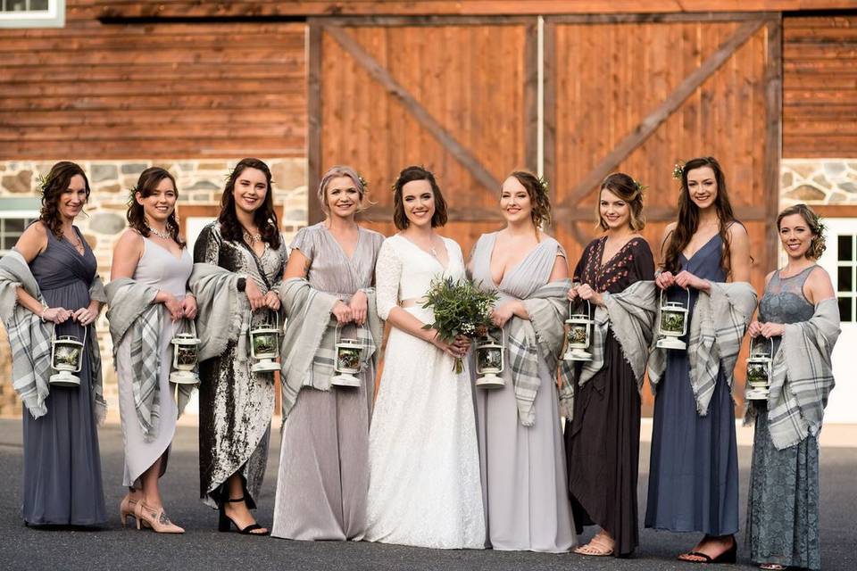 Bridesmaids in front of barn