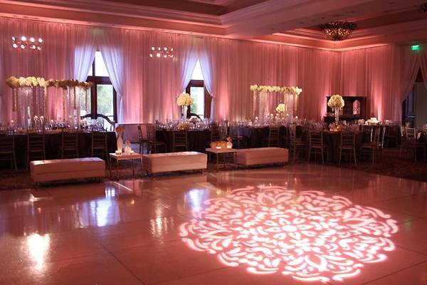 A defined pattern on the dance floor surrounded by lush satin draping will captivate your guests.