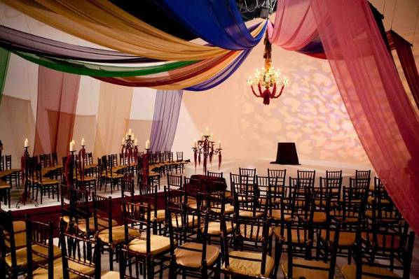 Candlelight uplights and pinspots that highlighted unique centerpeices adorned this wall draped ballroom. A custom image projection on the dance floor tied all the lighting elements together.