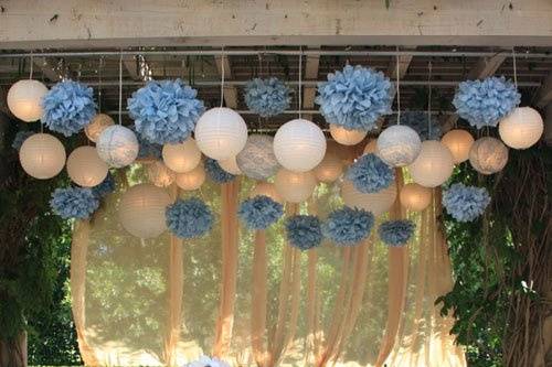 Ivory lanterns, lanterns with vintage blue lace and blue pom poms for a vintage inspired look. Champagne draping to complement.