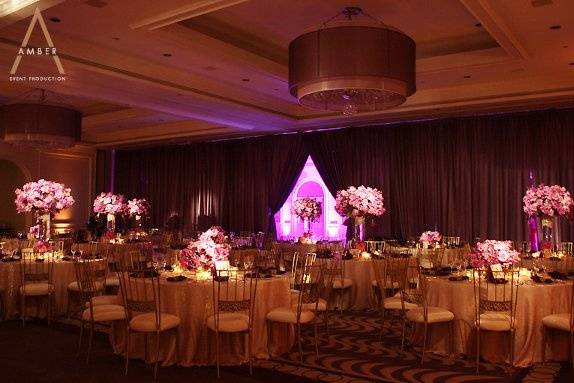 Chocolate amber uplights and pinspots on centerpieces and the hanging cake. Video screen and projector included.