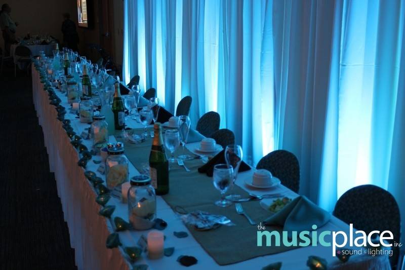 Tiffany blue uplighting behind a head table