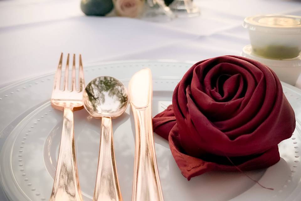 Rose napkins and gold flatware