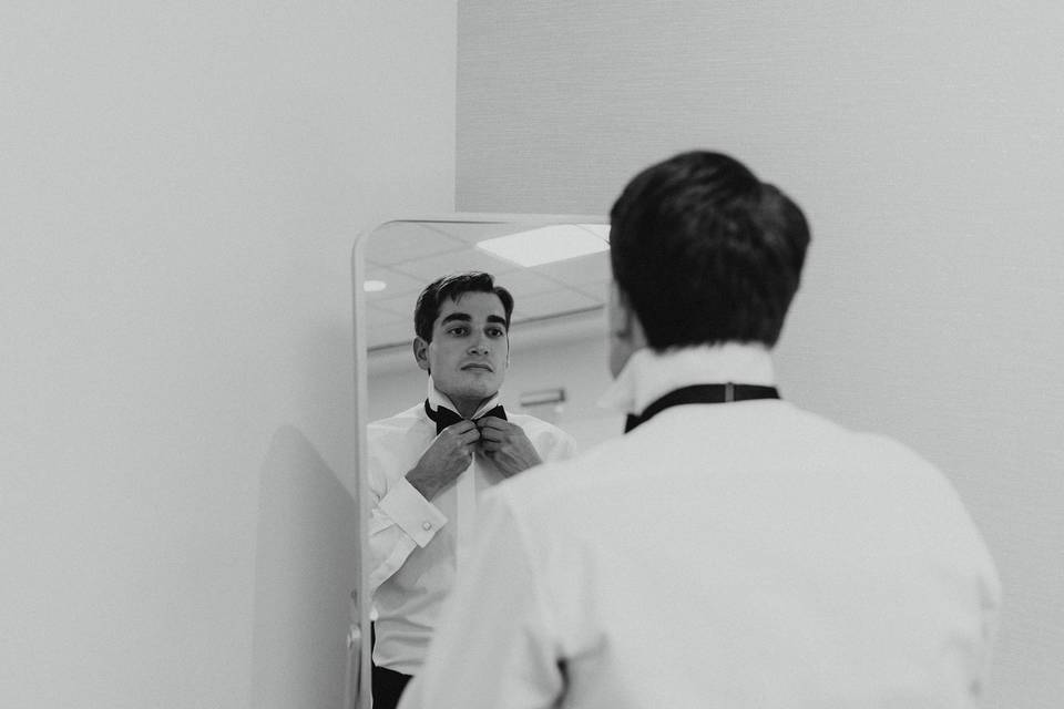 Groom getting ready in mirror