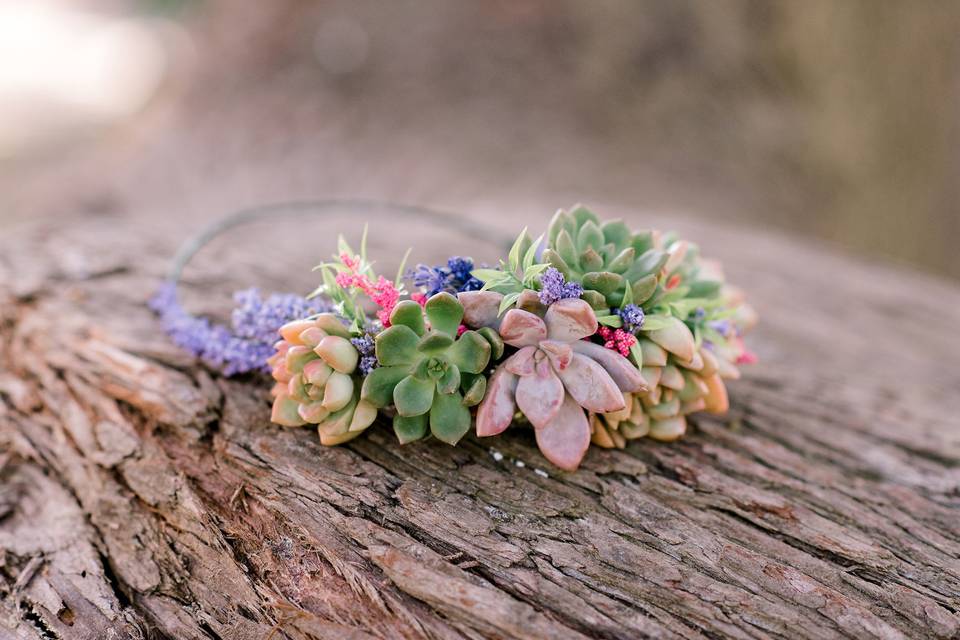 Succulents make for a sturdy bridal crown. This one includes artificial flowers for pops of pink and purple that won't wilt at the party.