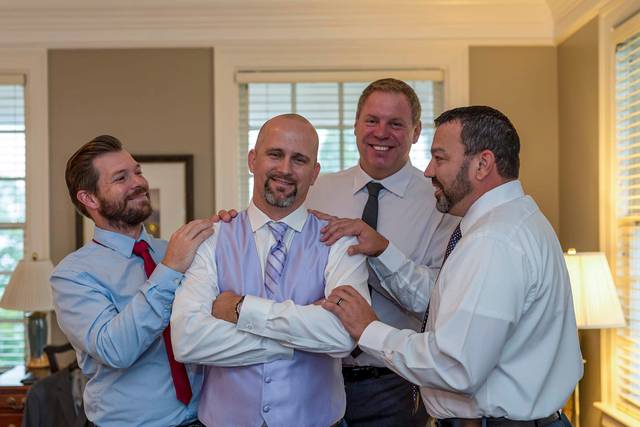 Groom laughing with Groomsmen