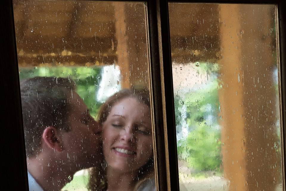 Groom Steals a Kiss by the Dining Room Door