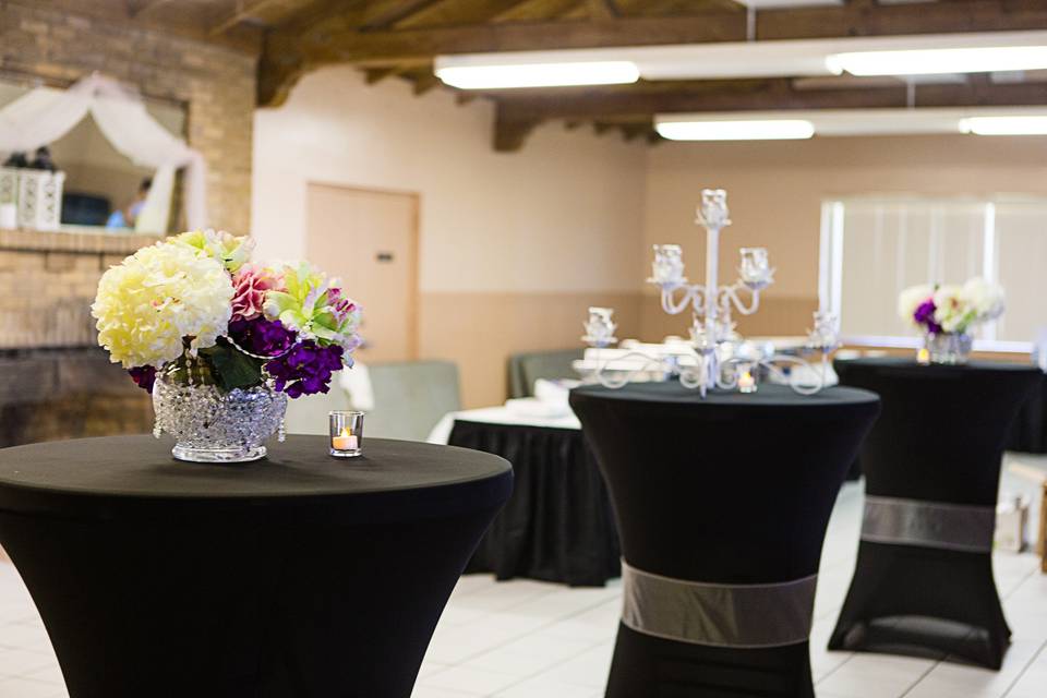 Cafe tables set up near the bar area - used with uplighting give those singles a place to mingle