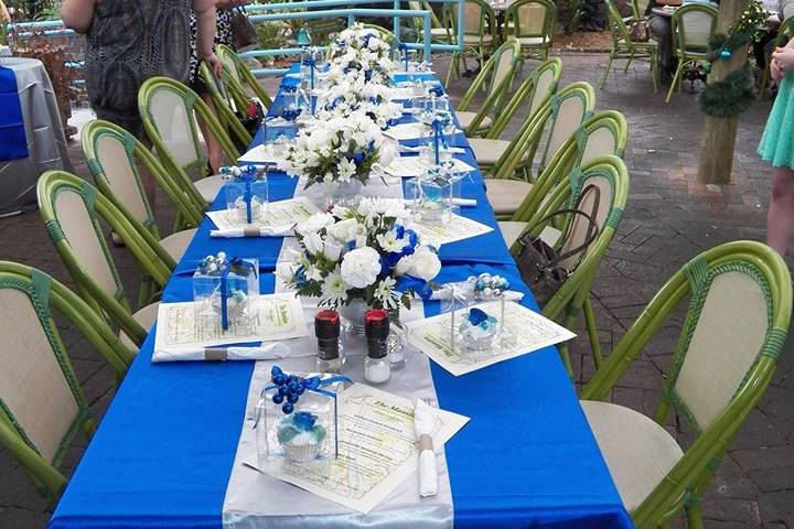 Royal blue, silver and white satin linens, fresh flowers, and special items made the table shine for this wedding shower.