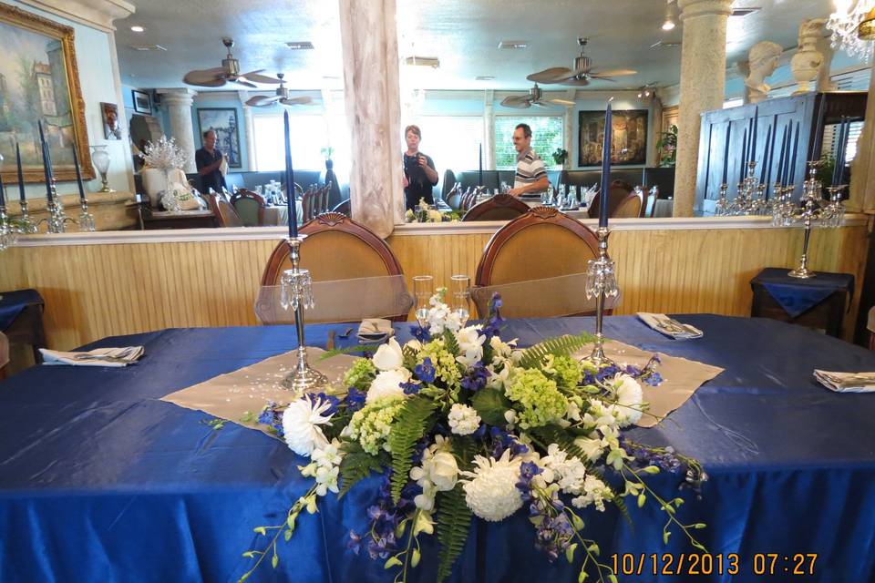 USAF colors - Navy and silver with a touch of white and red.   Fresh flowes, silver candalabras, and full butlered dinner service at a restaurant venue following church service.