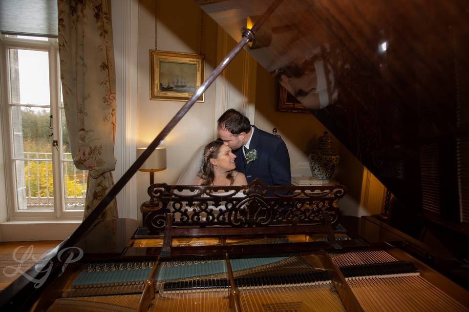 Loving couple by the grand piano