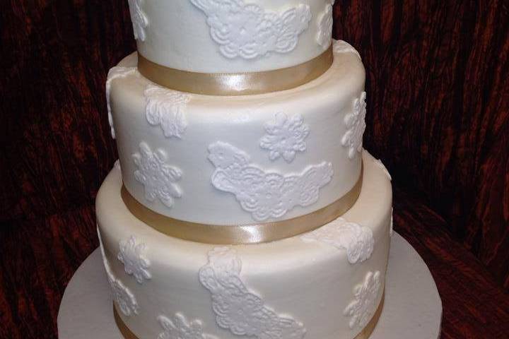 Wedding cake with gold ribbon