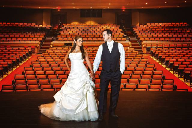 DCP wedding couple on stage alone in large theatre.