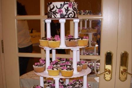 Cupcake tower for wedding. Cupcakes individually decorated with frosting. Mixture of chocolate and white/vanilla cupcakes with buttercream frosting.