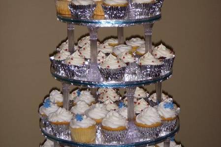 Cupcake tower for a wedding. 'Winter' theme. I did several flavors: chocolate with choc. ganache filling/Buttercream icing, Vanilla/Buttercream, Red Velvet/Cream cheese frosting, Lemon/Lemon Butter Icing. All decorations were edible and I custom made the display stand for the customer. Overall they wanted a simple winter theme with a few embellishments.