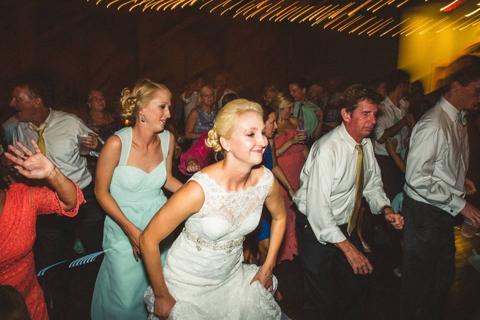 Newlyweds and guests line dancing