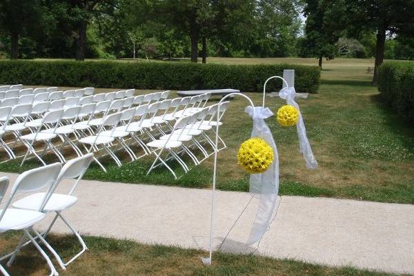 outdoor white wedding chairs and shepherd hooks. Location Pamperin Park Green Bay   Rental items
