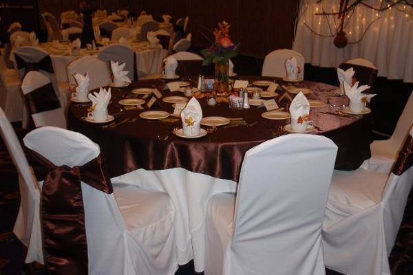 Rental chair covers, sashes and satin table overlay in chocolate brown