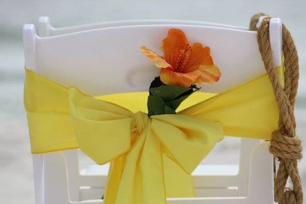 White resin chair with chair sash.