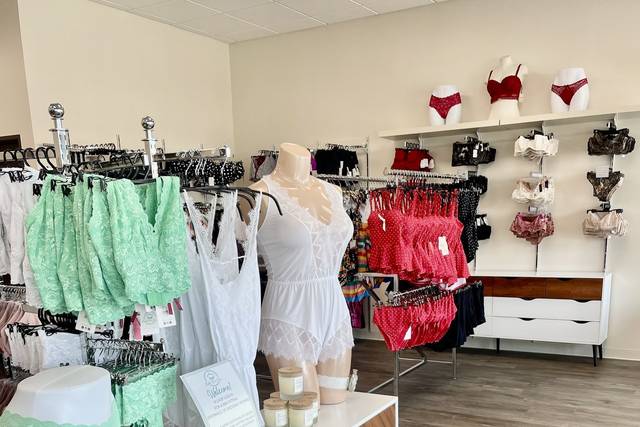 Female lingerie store showcase. Bras on hangers. High-quality