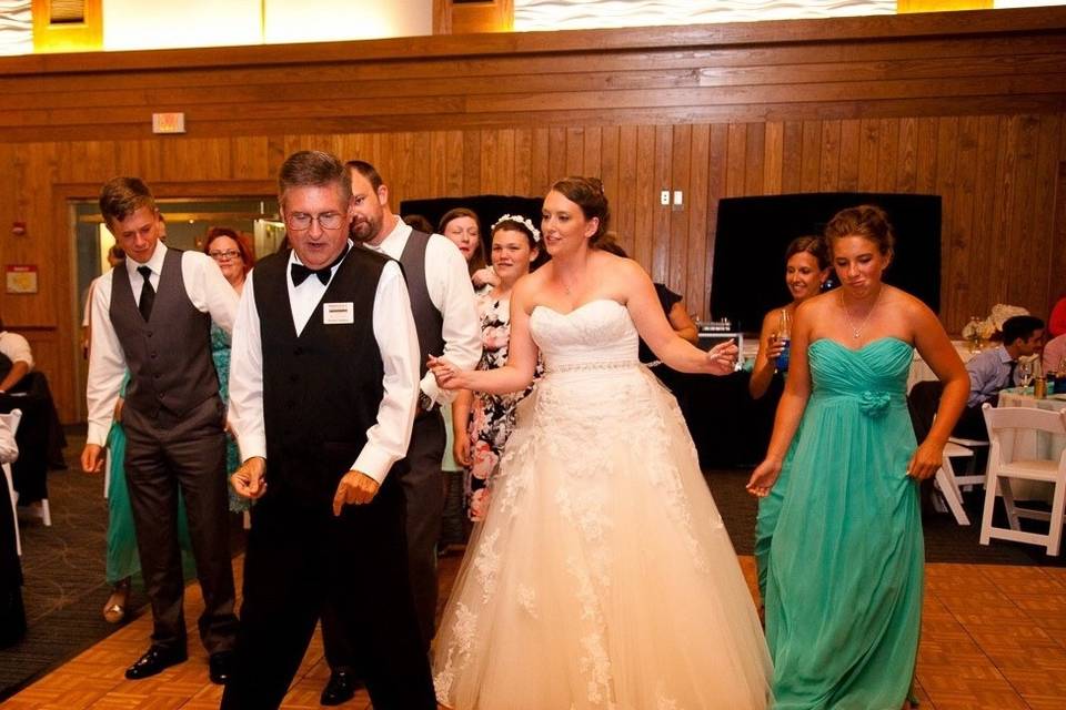 DJ Robert Batson dancing with the bride and groom