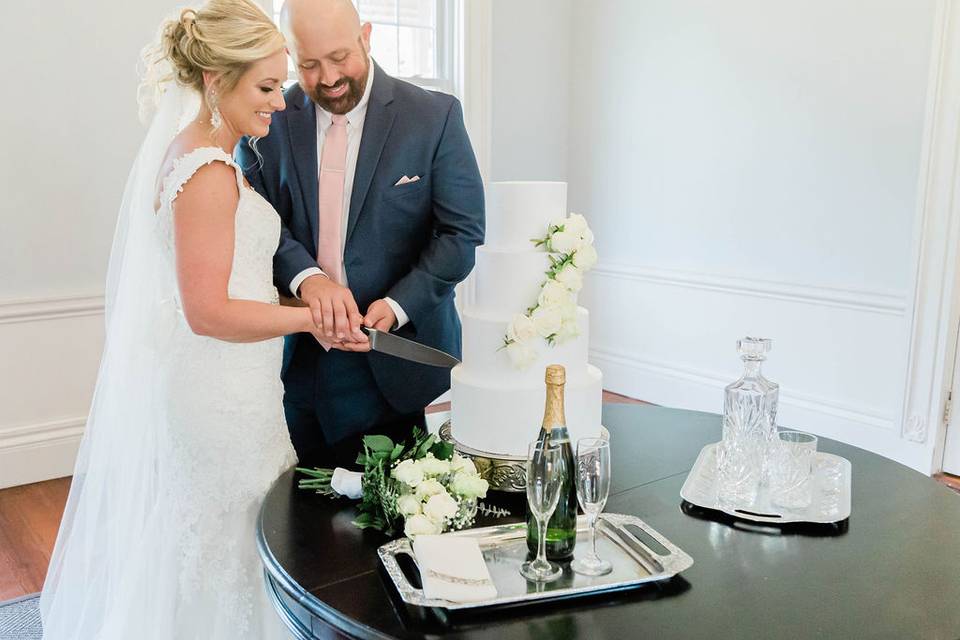 Wedding cake cutting in parlor