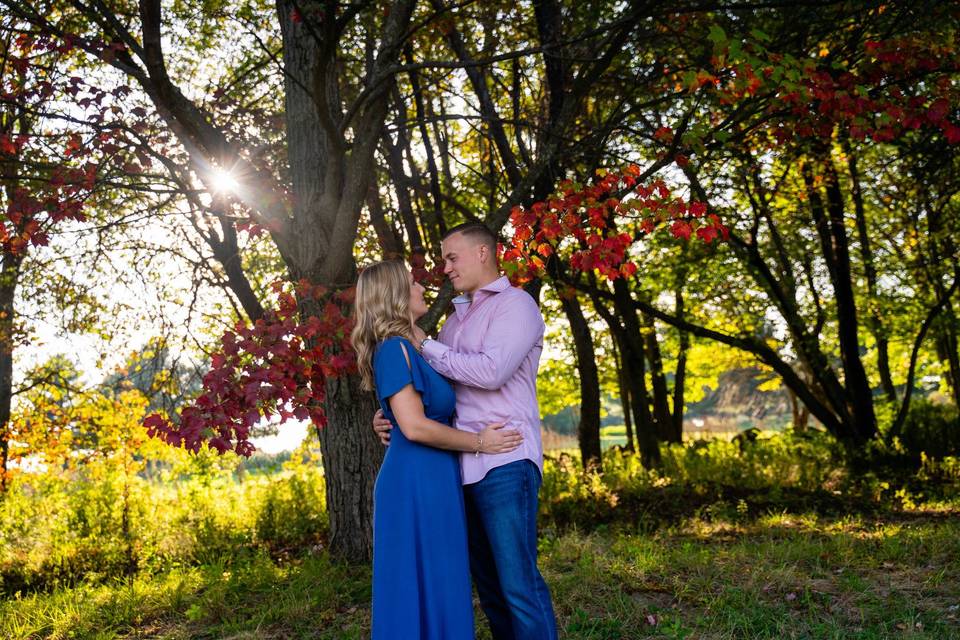 Engaged couple and fall trees