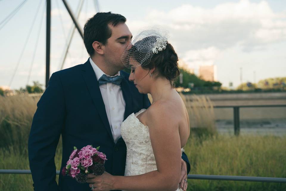 Groom kissing bride on forehead