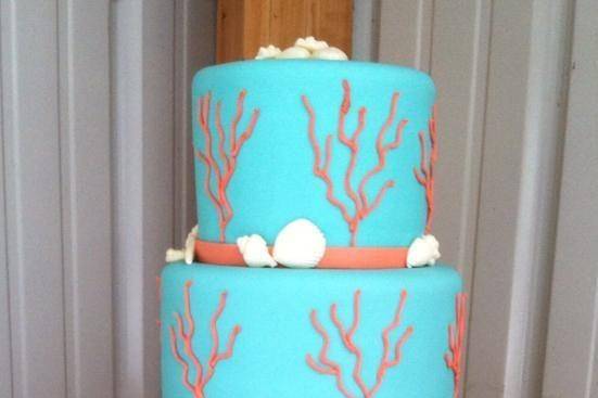 4-tier blue wedding cake with coral details