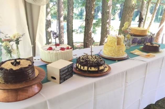 The trees are a perfect backdrop to a tasty cake table.
