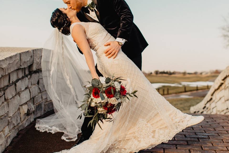 Couple kissing on bridge