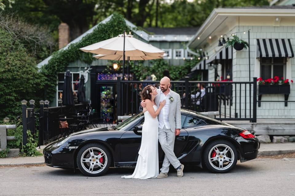 Newlyweds pose with Porsche