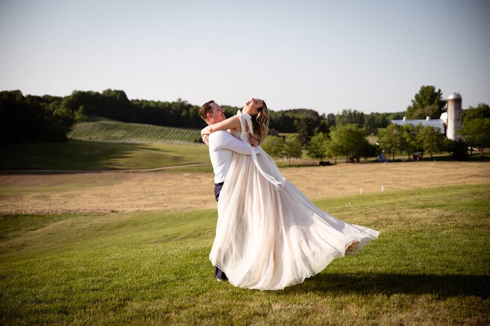 Groom lifts & twirls bride