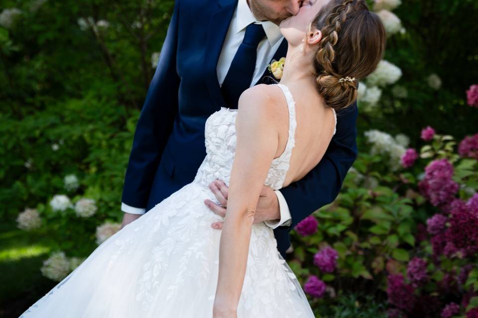 Newlyweds kiss in a garden