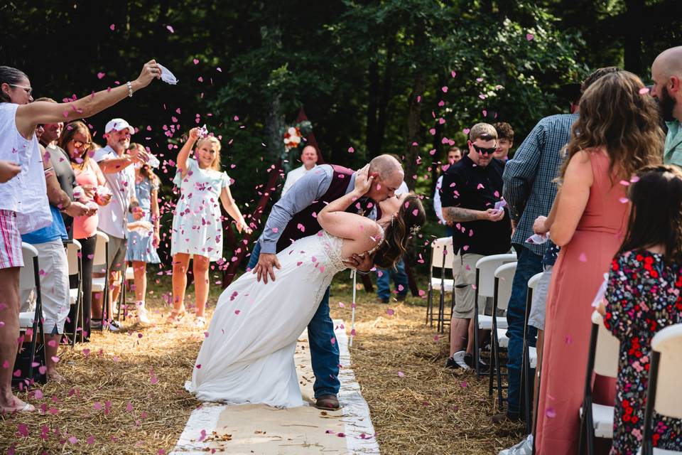 Newlyweds dip and kiss
