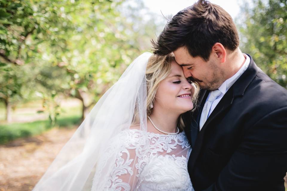 Newlyweds in apple orchard