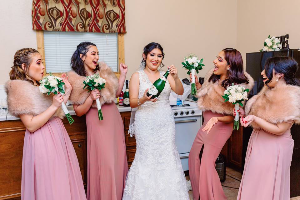 Bride and maids popping a top