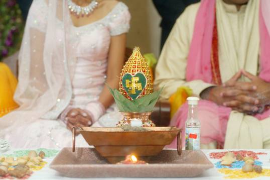 The havan, agni puja (lighting of the fire) m, the bride and groom in the mandap at a hindu ceremony. According to the hindus, fire a considered a sustainer of life. It symbolizes purity and sacrifice. In the presence of agni (fire0, darkness and ignorance are dispelled from one's life and leads to one to eternal light and knowledge.