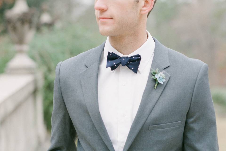 Grey suit with navy bow tie