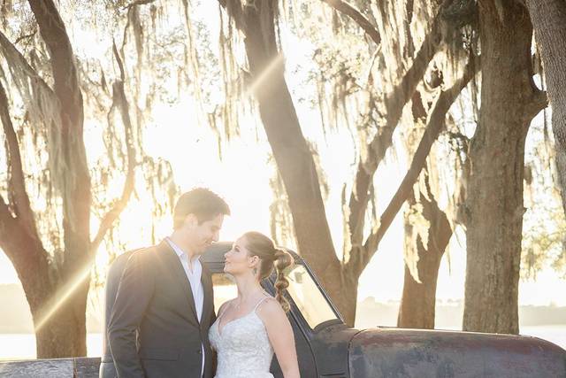 Couple standing by an antique car