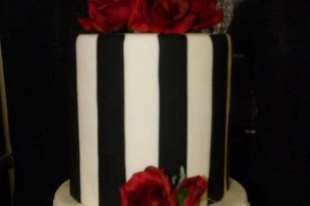 3-tier black and white striped Wedding Cake with red roses.