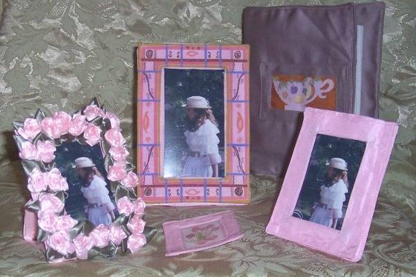 These frames are of various sizes, all washable, sewn, and fabric, same with the minimax photo album cover.  I printed designs onto fabric, and applied them to the items.  The ribbon roses are sewn and glued onto the frame front