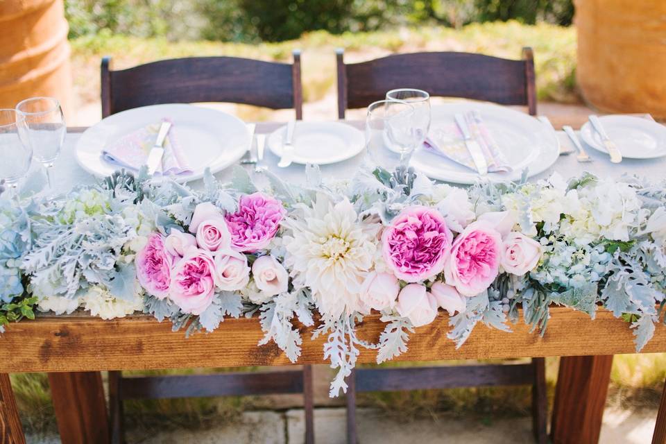Dahlias and garden roses make a beautiful sweetheart table swag.
